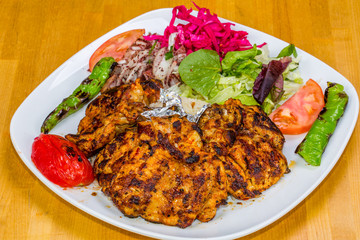 Turkish cuisine. Chicken chop on bone (pirzola) with vegetables