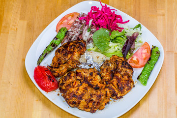 Turkish cuisine. Chicken chop on bone (pirzola) with vegetables
