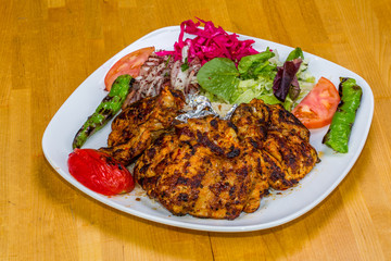 Turkish cuisine. Chicken chop on bone (pirzola) with vegetables