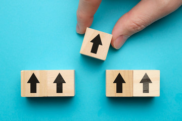 Personnel promotes concept - wooden blocks with abstract arrows on a blue background.