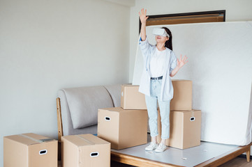 Fototapeta premium Asian young girl using VR glasses at home