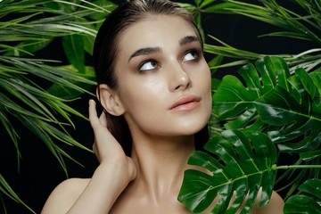 Beautiful woman green leaves exotic charm