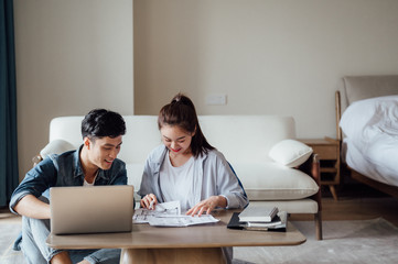 Young Asian couple at home using computer