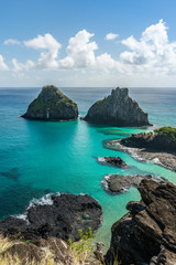 Fototapeta na wymiar Aerial view of Dois Irmaos Hill at Baia dos Porcos beach, with turquoise clear water, at Fernando de Noronha Marine National Park, a Unesco World Heritage site, Pernambuco, Brazil