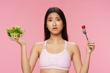 mixed race woman holding salad