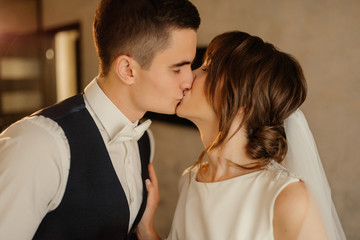Bride and groom kiss at the first meeting. The first meeting of the bride and groom. First look of wedding couple in the morning. Wedding couple in the hotel. Bride and groom.