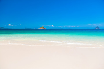 Fototapeta na wymiar Beautiful tropical beach with white sand, clear water and blue sky. Khai Island, Phuket, Thailand