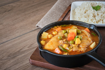 stewed chicken with vegetables potatoes, carrots, peas, chickpeas served with rice