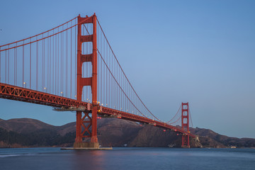 The famous Golden Gate Bridge in San Francisco, California. Beautiful sunlight hitting the bridge as cars drive over it. 