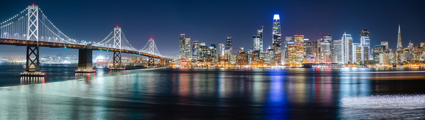 Nighttime view of San Francisco city. Calm and peaceful conditions in the bay as the city light illuminate the water. 