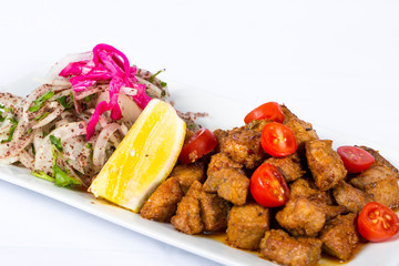  liver with onion and lemon on a plate