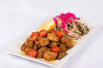  liver with onion and lemon on a plate