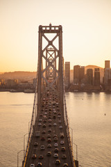 Beautiful golden sunset behind the San Francisco city while traffic stands still on the iconic...