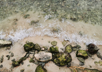 Fine sand, big and small rocks from the shores of a peaceful beach in Riviera Maya, Mexico.