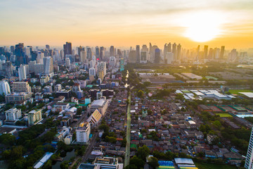 Bangkok downtown city office building with green park sunset aerial view