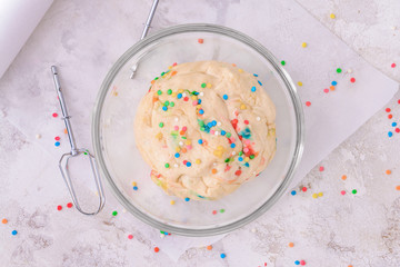 Bowl with sweet dough on table