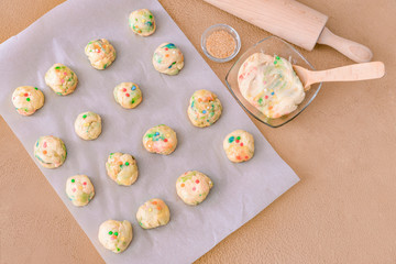 Uncooked cookies on color background