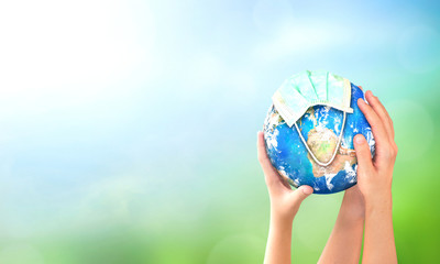 Earth Day concept: Corona virus or COVID-19 Earth wearing a mask , this image furnished by NASA