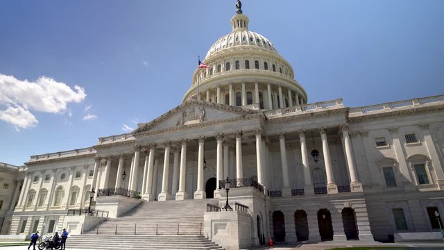 Slow panning motion of the US Capitol on a day with a cloudless blue sky.