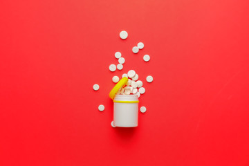 Bottle with pills on color background