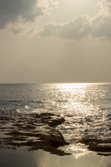 A portrait shot of the Indian Ocean and rocky beach of Neil island with interesting cloudscape