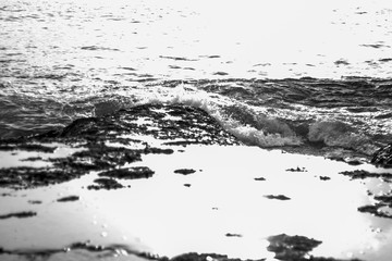 A black and white shot of the Indian Ocean waves crashing on Rocky beach of Neil Island