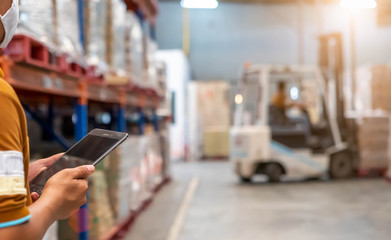 The  man holding tablet to checking the stock products,