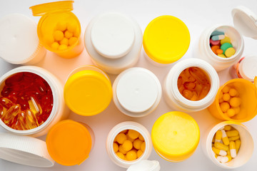 Bottles with pills on white background