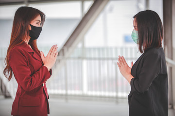 Greeting model thai wai in order to keep social distance in coronavirus covid 19 world pandemic,...