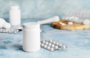 Bottle with pills on color background