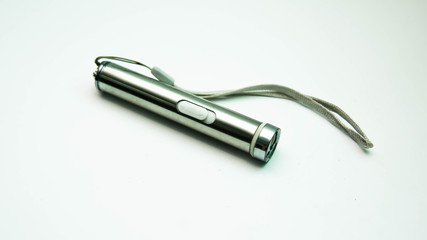 A pocket light torch on isolated white background