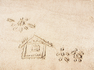House and sun on yellow sand drawn by finger, close up view. Yellow sand texture. Egyptian beach in february. Selective soft focus. Blurred background