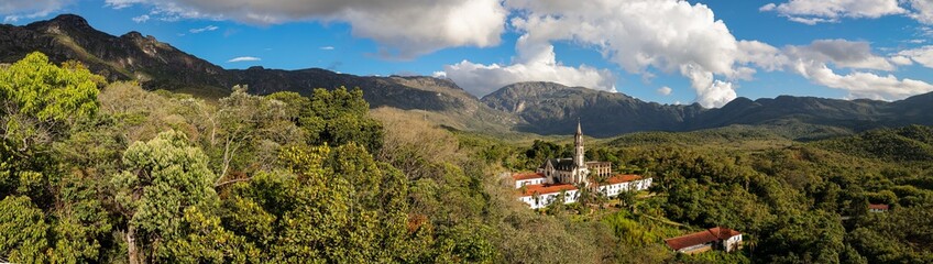 Fototapeta na wymiar Aerial view panorama of Sanctuary Caraca with shadows, mountains, blue sky in background, Minas Gerais, Brazil