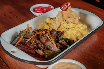 Peruvian food lomo saltado :A salted beef with tomatoes, onion, fried potatoes and rice.