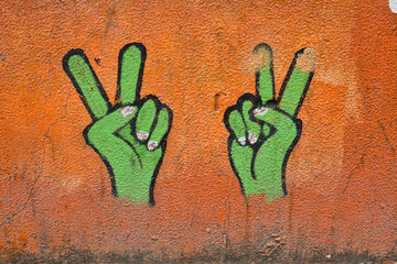 Street scene of two symbolic hands doing the peace sign, standing in for peace