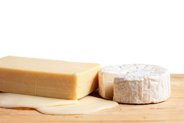 Different types of cheese on the wood with brown paper background.