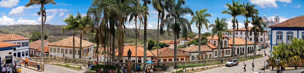 Panorama of traditional houses and palm tree lined street in historic center of Diamantina on a sunny day, Minas Gerais, Brazil