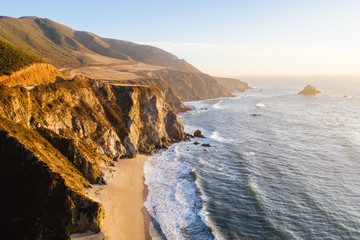 Aerial drone view of the Big Sur coastline in California. Beautiful golden light hitting the side...