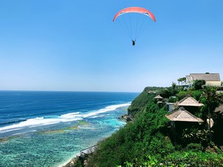 paraglider over the beach bali resort indonesia