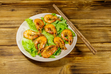 Tasty baked shrimps on a wooden table