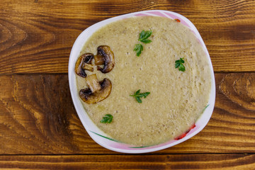 Mushroom cream soup on a wooden table. Top view