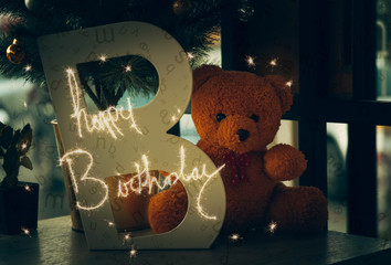 Brown teddy bear with happy birthday message.  
