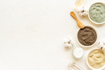 Clays set for face mask on white table top-down frame copy space