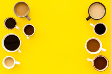 Coffee addiction. Many of cups on yellow table top view space for text