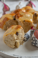 Traditional home made hot cross buns with chocolate chips on a easter table