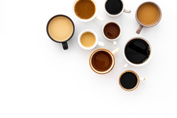 Different cups of coffee on white table top-down space for text