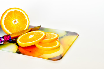 GMO stop. sliced orange lie on a cutting board, on a white background. vitamins