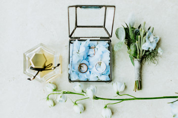 wedding ring and flowers with perfume lay flat