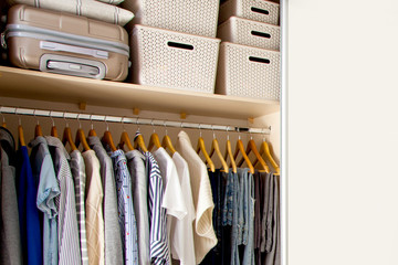 Wardrobe with perfect order clothes shades. Copy space.