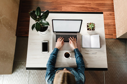 Woman working, learns, using laptop computer on table. Writing, typing. Blank screen, cell phone. Freelance concept. Work home. Online education, shopping. Communication, technology concept. Top view.